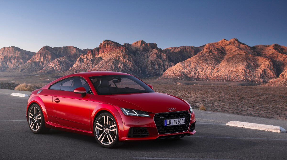 A red Audi TT shows off its coupe body.