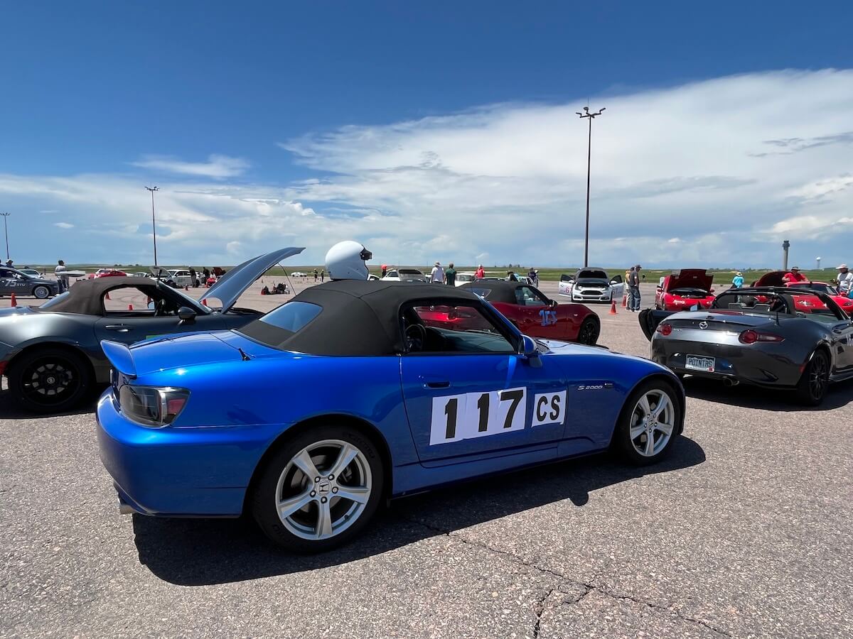 A blue Honda S2000 in the pit lanes