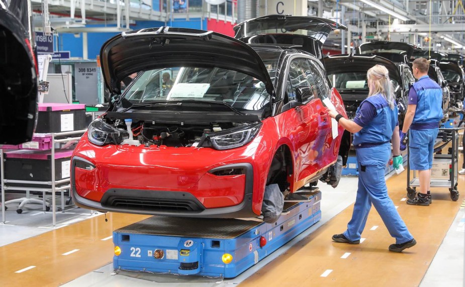 Factory workers assemble the BMW i3 EV with range-extender in Germany.