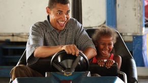 Former President Barack Obama drives a bumper car.