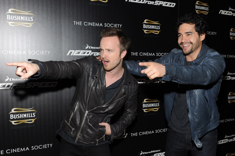 Actors Aaron Paul and Ramon Rodriguez point and smile during DreamWorks Pictures' "Need For Speed" screening 
