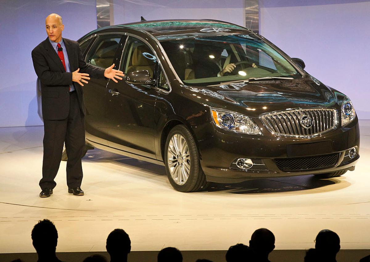 A Buick Verano being debuted at an auto show.