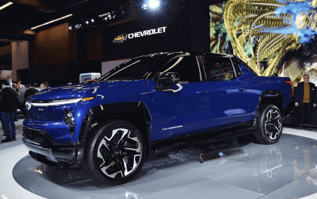 A blue Chevy Silverado EV on display at an auto show.