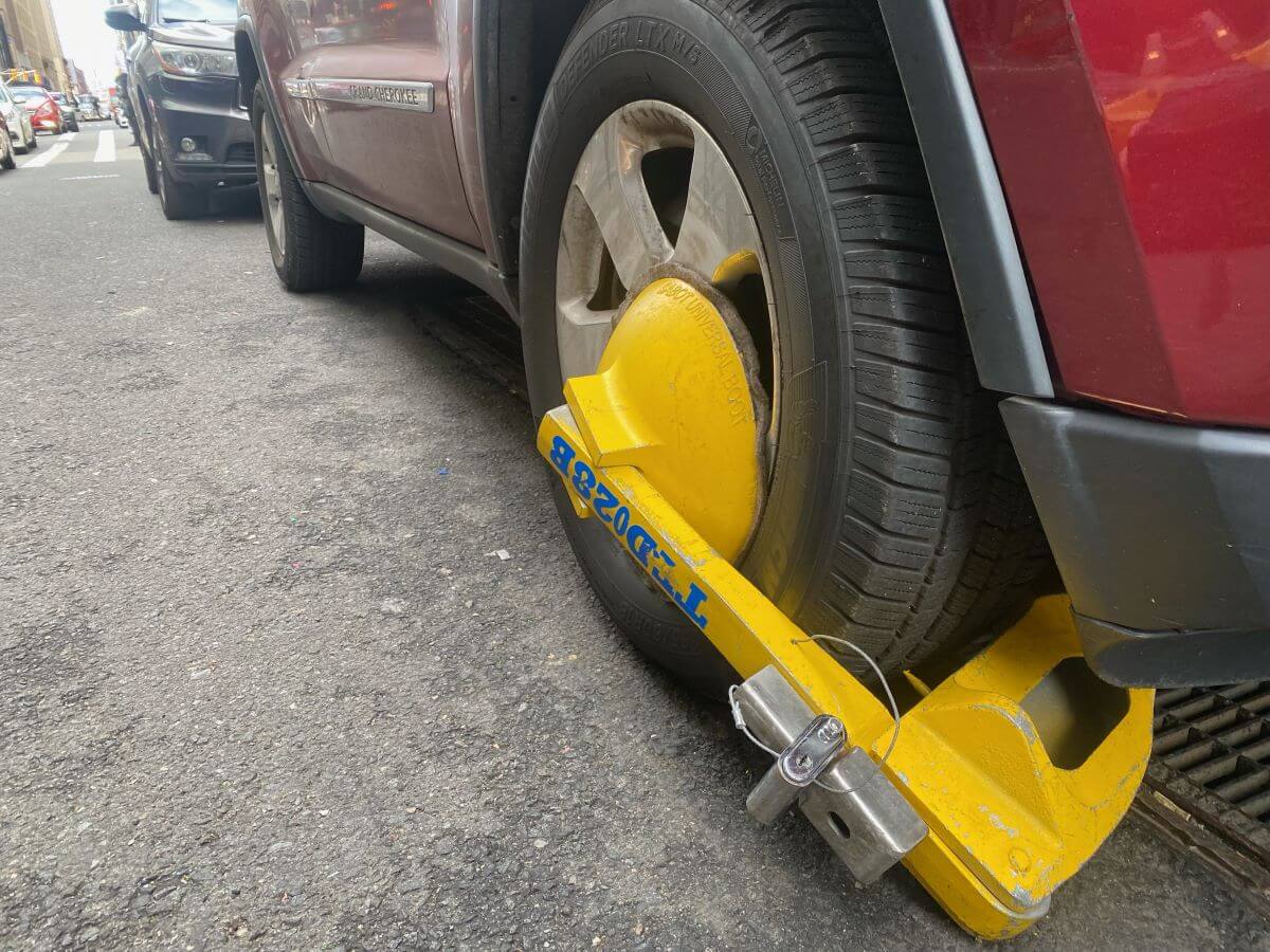 A Denver Boot device attached to a car in New York City for outstanding parking tickets