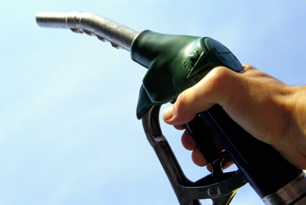 Petrol Pump held in the air by a disembodied hand.