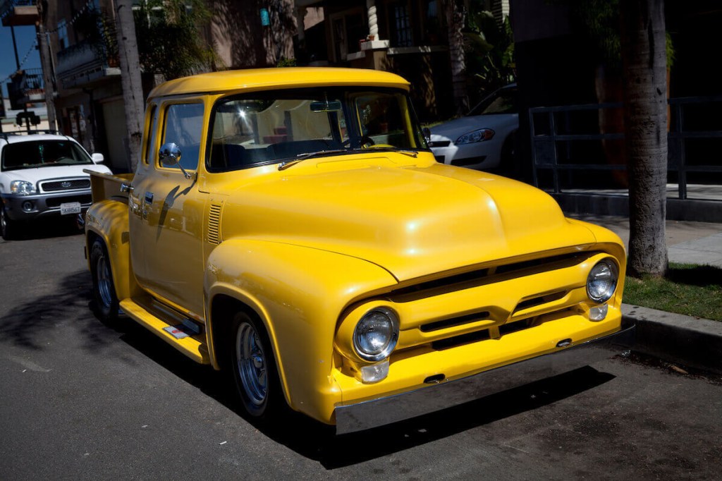 Yellow pickup truck parked on the street - used trucks in this color could have a higher resale value