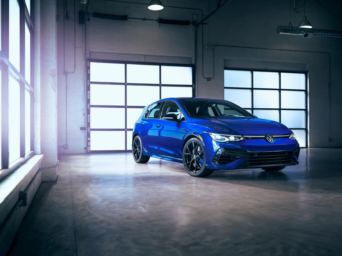 A blue 2023 Volkswagen Golf R parked in a garage