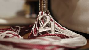 Closeup of a a graduation tassel with the number "21" attached to it.