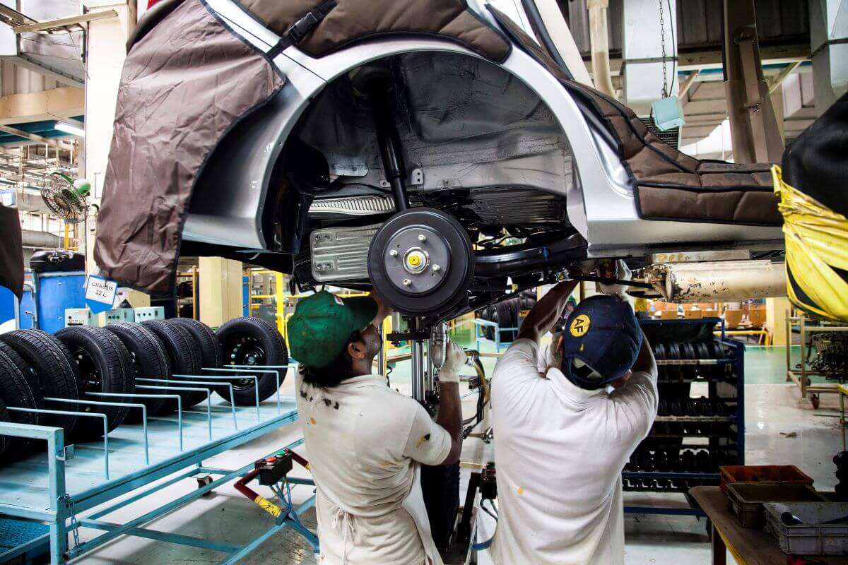 The production assembly process of axle work on a Honda Mobilio model at a plant in Greater Noida, India