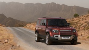 2023 Land Rover Defender in red on a road in the desert