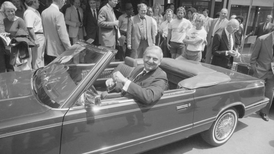 Chrysler Chairman Lee Iacocca sitting in the front seat of a 1982 1/2 Chrysler LeBaron Convertible prototype