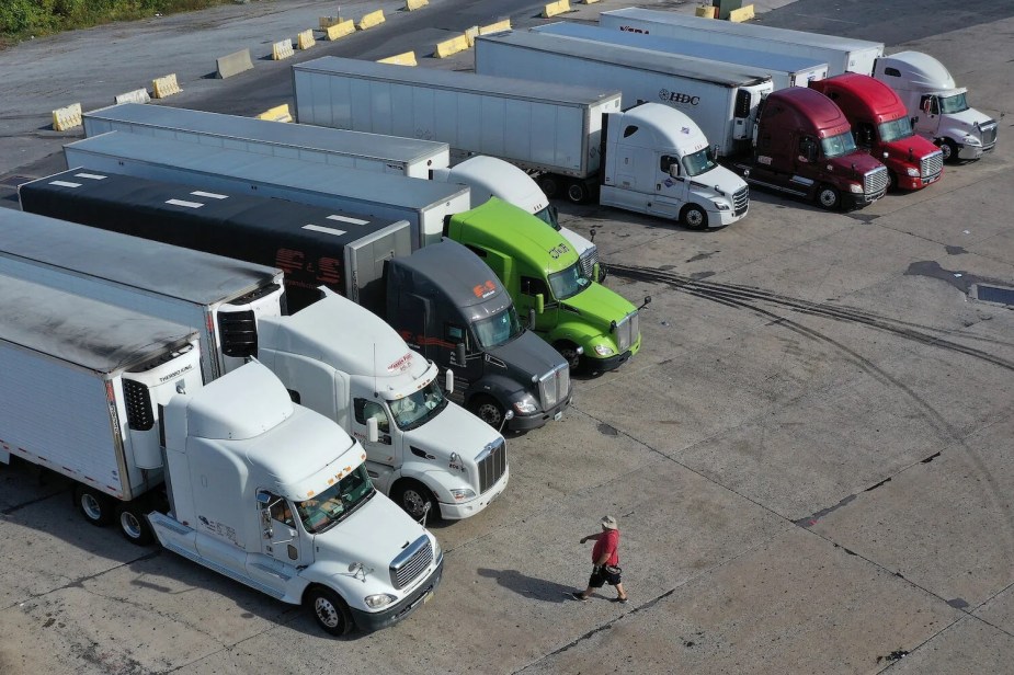 Birds-eye view of a parking lot full of semi-trucks and semi-truck trailers registered in Maine.