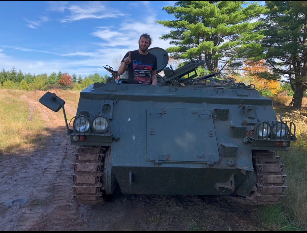 Peter Corn driving a tank in Monticello, NY