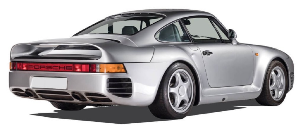 A silver Porsche 959, fitting car for a billionaire, shows off its rear-end styling. 