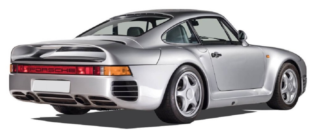 A silver Porsche 959, fitting car for a billionaire, shows off its rear-end styling.