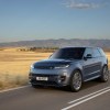 The 2024 Land Rover Range Rover Sport driving down a desert road in gray.