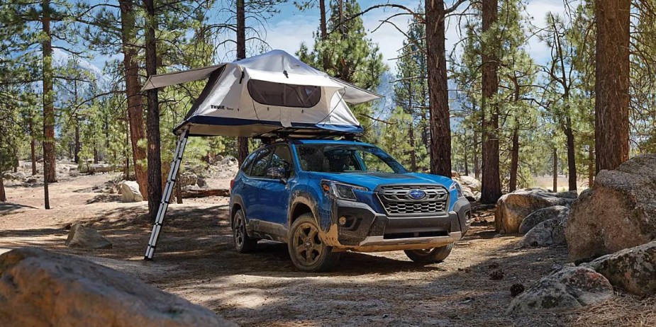 A blue 2023 Subaru Forester Wilderness is parked off-road, one of the ways it beats the Toyota RAV4.