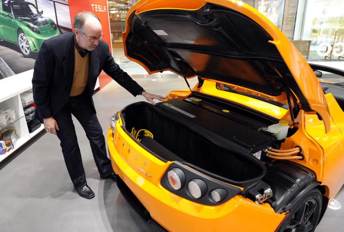 The original Tesla Roadster with its trunk open showing off decent cargo space for an electric sports car