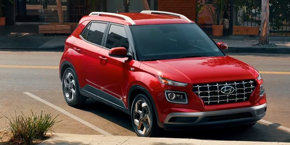 A red 2023 Hyundai Venue subcompact SUV is parked. 
