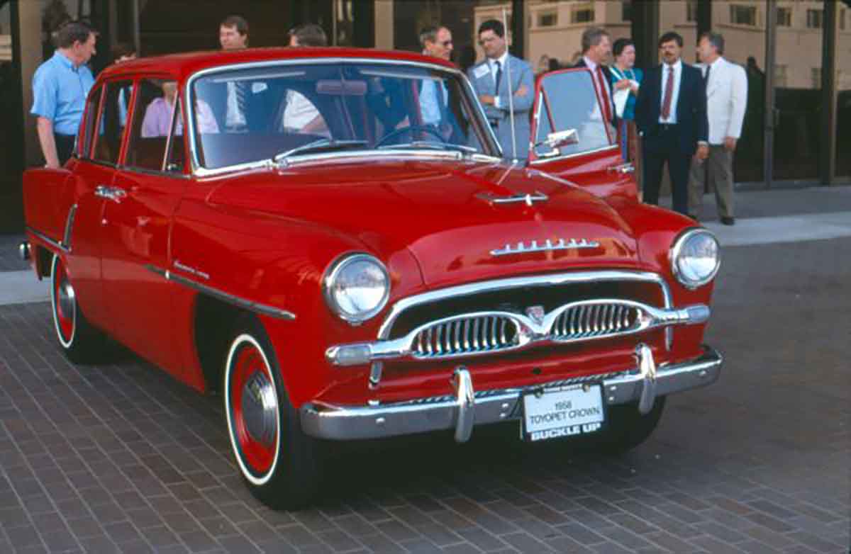 Toyopet Toyota Crown 1958 in red front 3/4 with matching wheels parked at auto show 