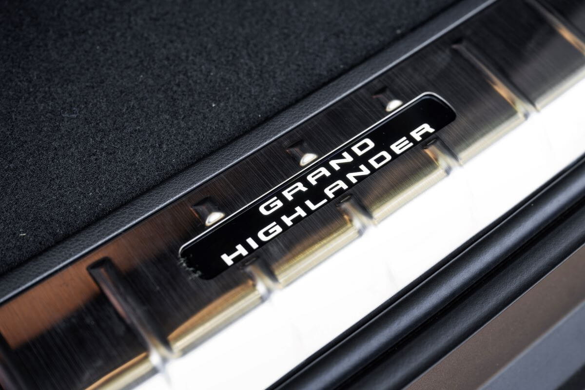 A 2024 Toyota Grand Highlander Platinum model badging print on the interior door frame