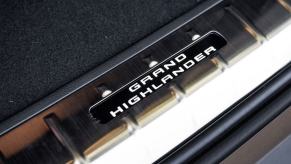 A 2024 Toyota Grand Highlander Platinum model badging print on the interior door frame