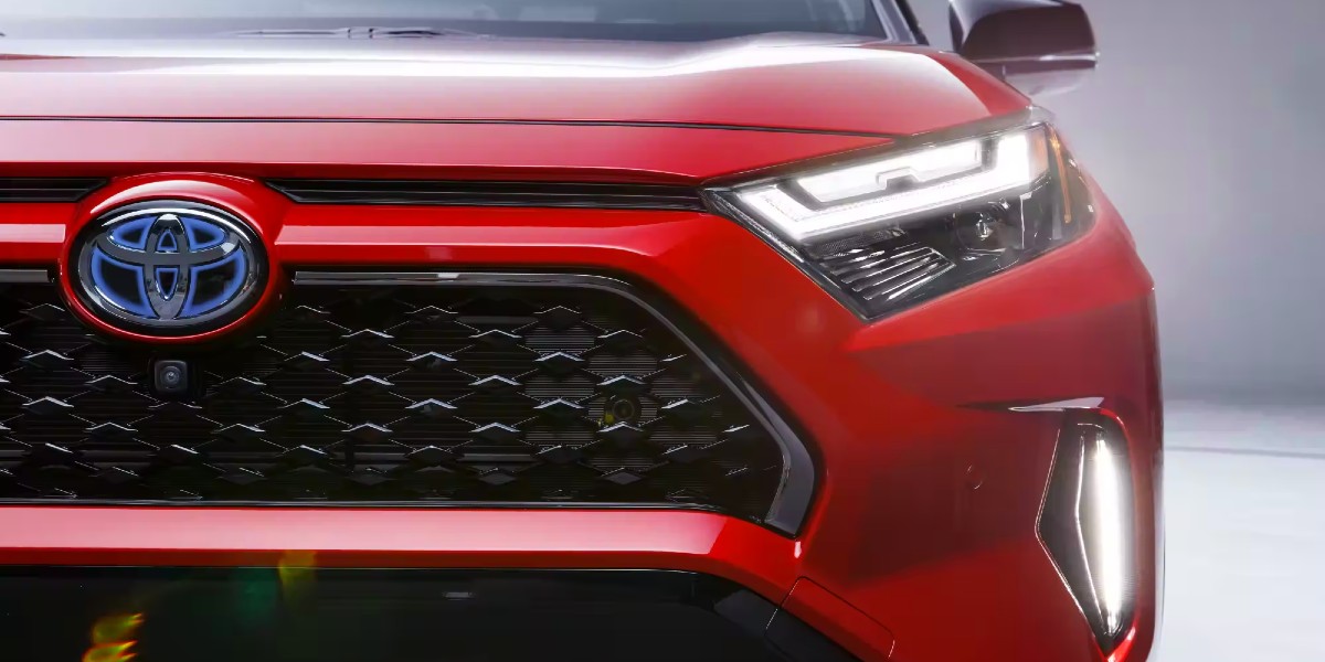 The front of a red 2023 Toyota RAV4 Prime small plug-in hybrid SUV.