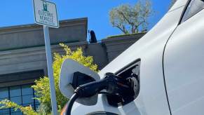 A close-up shot of an electric car plugged into a charger.