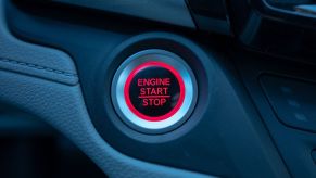 An engine start and stop button on the dashboard of a car's interior in Lafayette, California