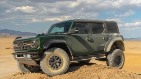 Green Ford Bronco Raptor in the California Desert sitting on top of dirth ill