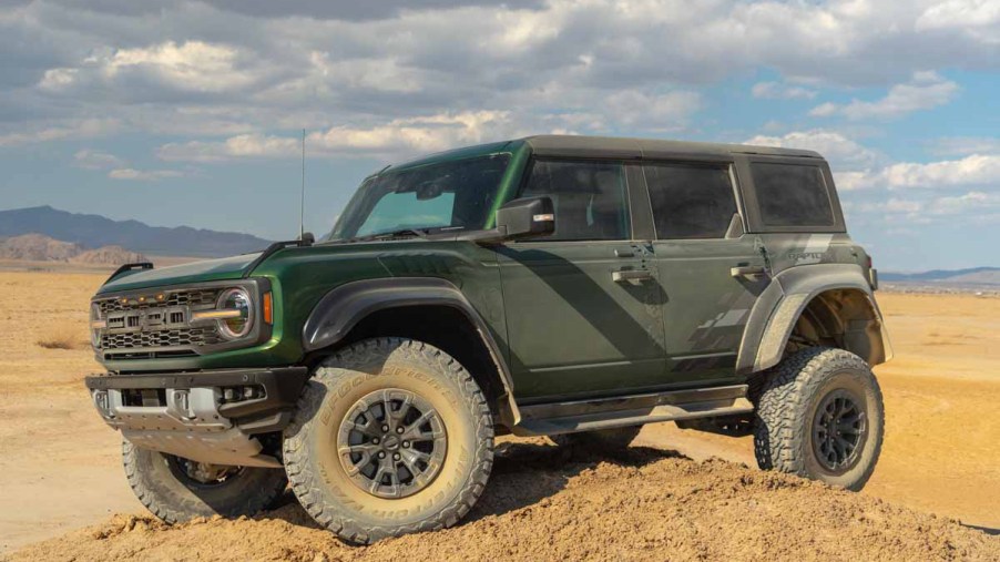 Green Ford Bronco Raptor in the California Desert sitting on top of dirth ill