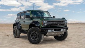 Green Ford Bronco Raptor sitting on a dry lake bed in Southerrn California