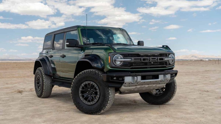 Green Ford Bronco Raptor sitting on a dry lake bed in Southerrn California