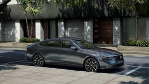 A 2023 Honda Accord Touring midsize sedan model parked on a street curb under tree shade