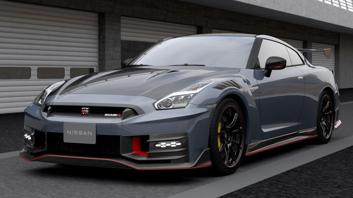 A 2024 Nissan GT-R NISMO performance sports car coupe model parked outside a line of garage doors