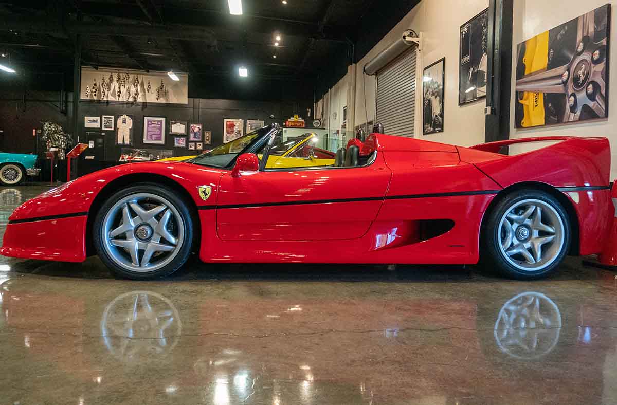 Red Ferrari F50 with reflection on smooth floor in Marconi Automotive Museum