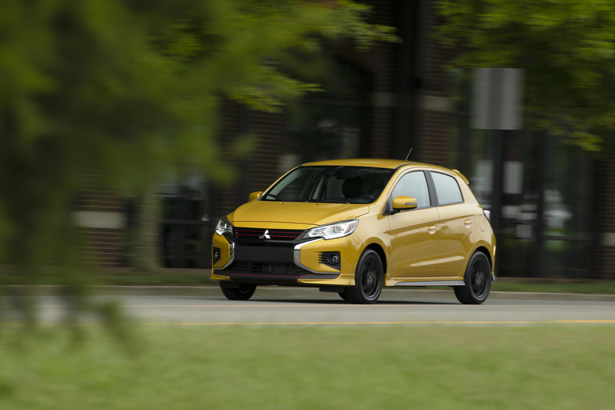 2021 Mitsubishi Mirage same as 2023 model year bright yellow driving down forest road 