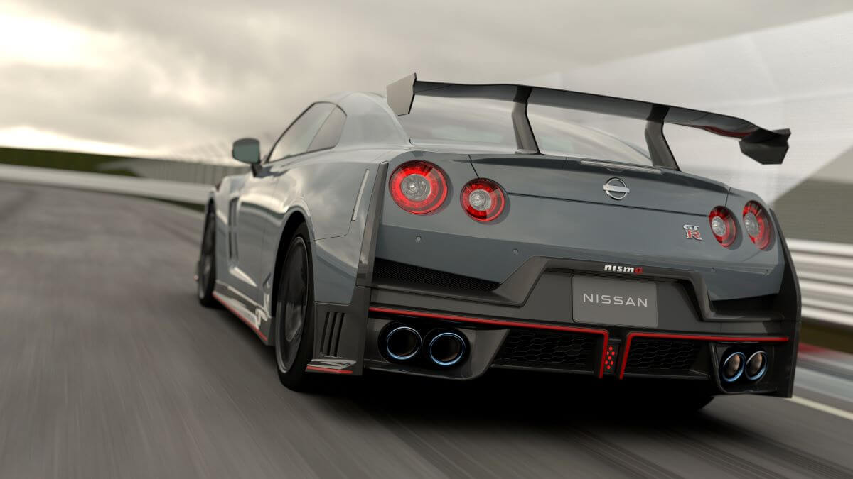 A rear wing and trunk shot of the 2024 Nissan GT-R NISMO sports car coupe model on a racetrack