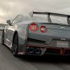 A rear wing and trunk shot of the 2024 Nissan GT-R NISMO sports car coupe model on a racetrack