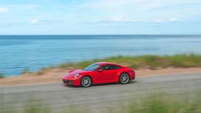 A red Porsche 911 sports car with all-wheel drive