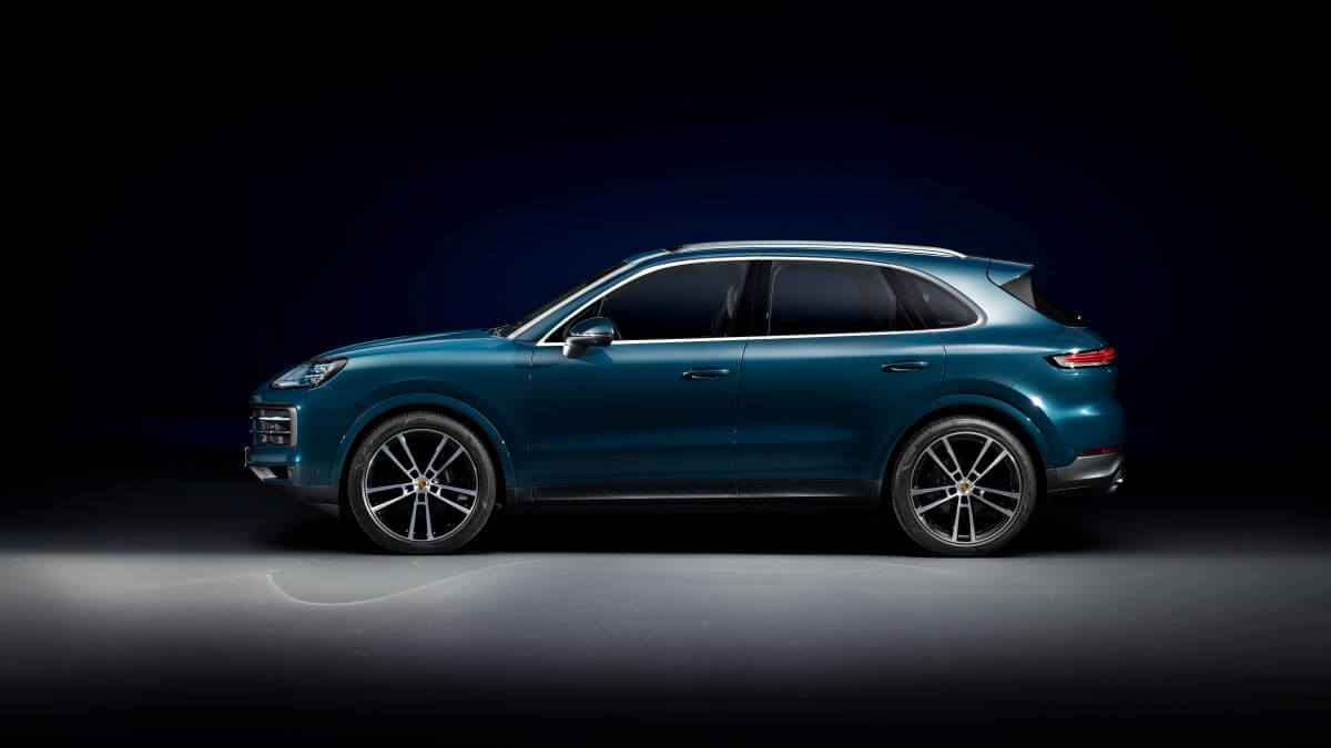 A side profile studio promotional shot of a blue Porsche Cayenne high-performance midsize luxury SUV model