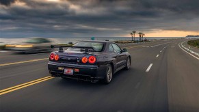 R34 Nissan Skyline GT-R V-Spec Midnight Purple II Driving Down Beach in Sunset