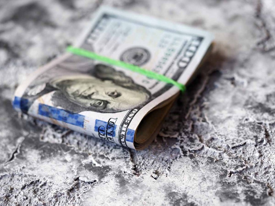 A folded wad of $100 US bills sitting on a table