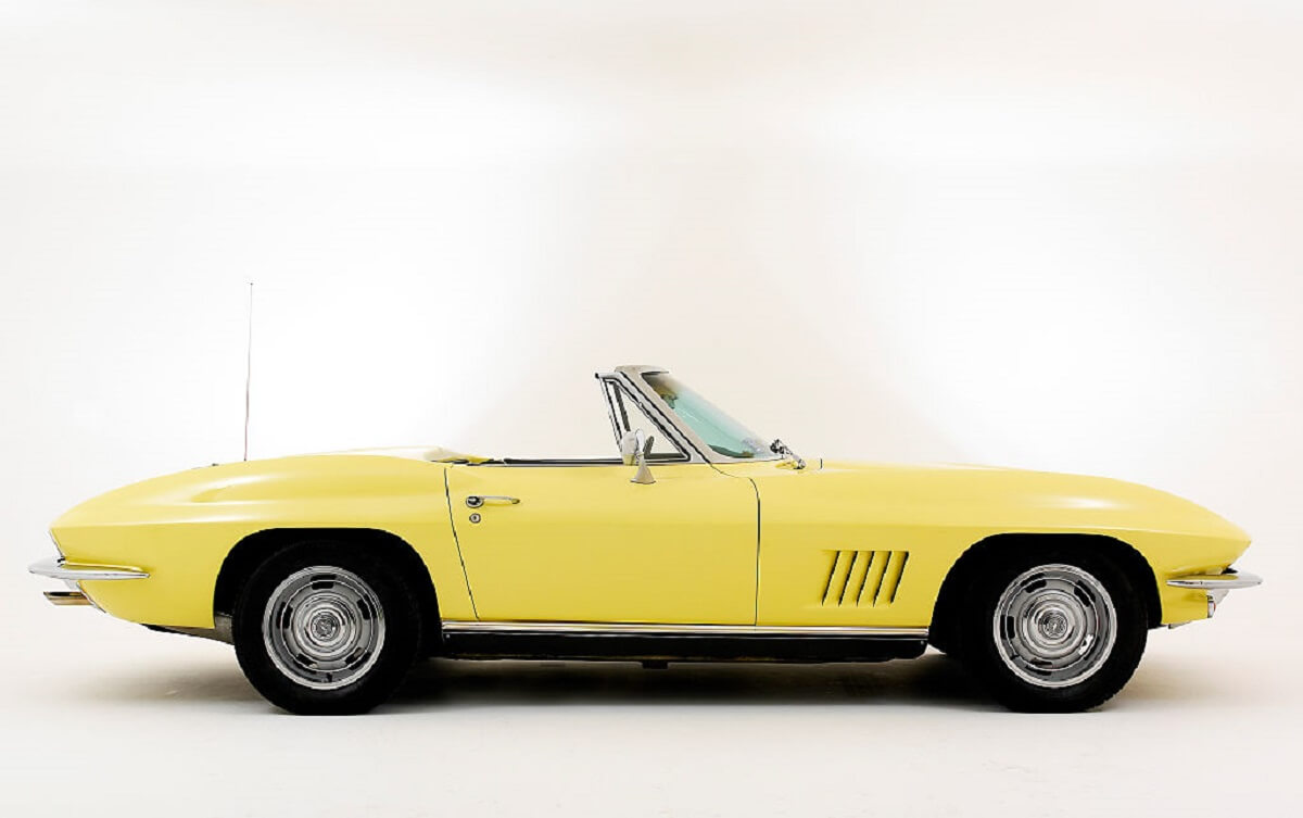 A yellow 1967 Chevrolet Corvette shows off its side profile. 