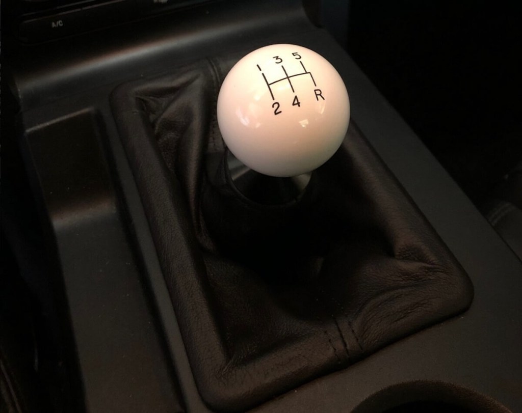 A cue ball stick shift knob shows off its five-speed layout in a 2008 Ford Mustang Bullitt with a manual transmission. 