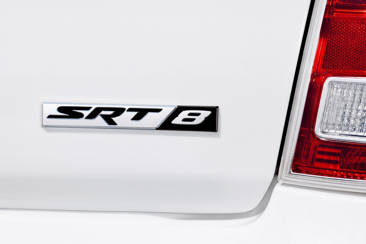 A white 2012 Chrysler 300 SRT8 shows off its badge.