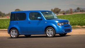 The 2014 Nissan Cube driving down the road