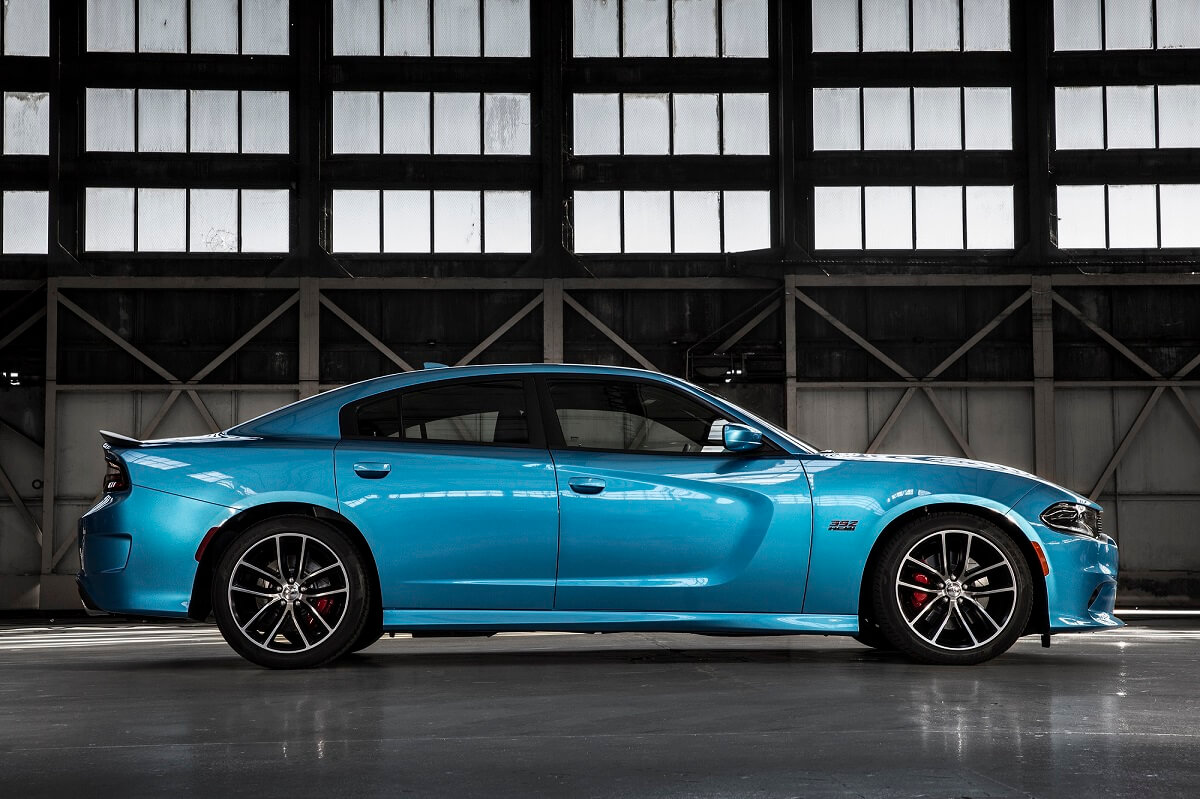 A blue 2015 Dodge Charger SRT Hellcat shows off its profile in a hangar.