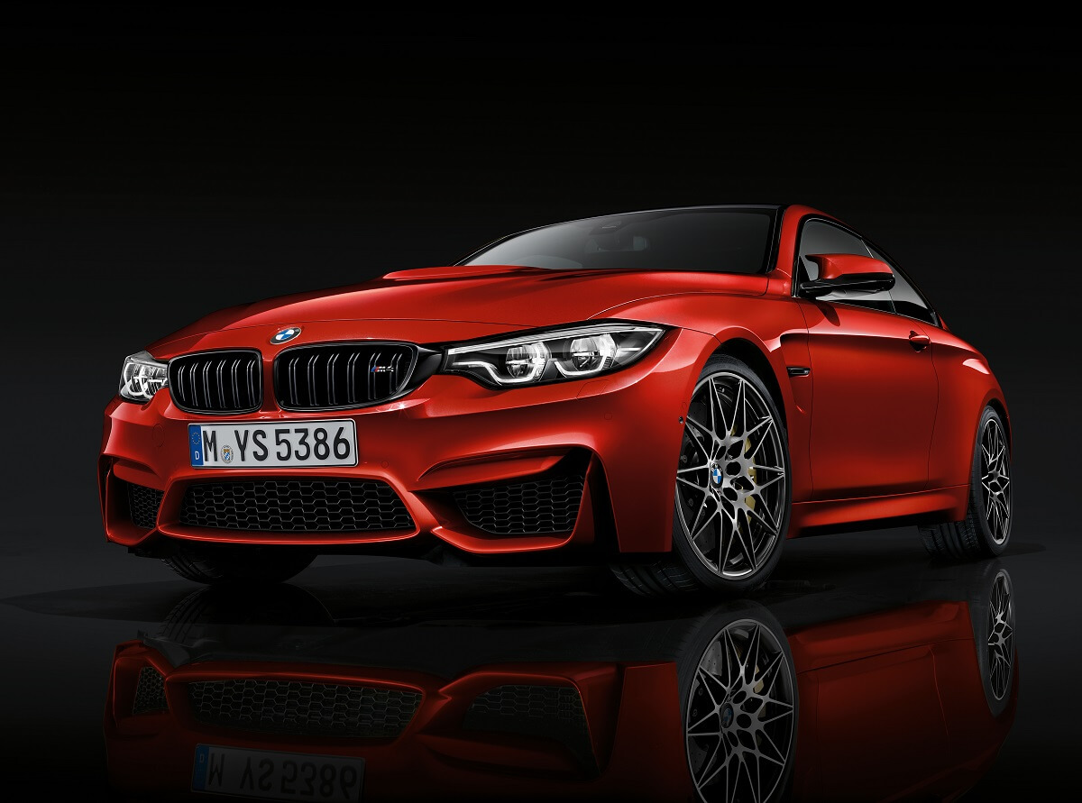 An orange 2018 BMW M4 shows off its angular front-end fascia.