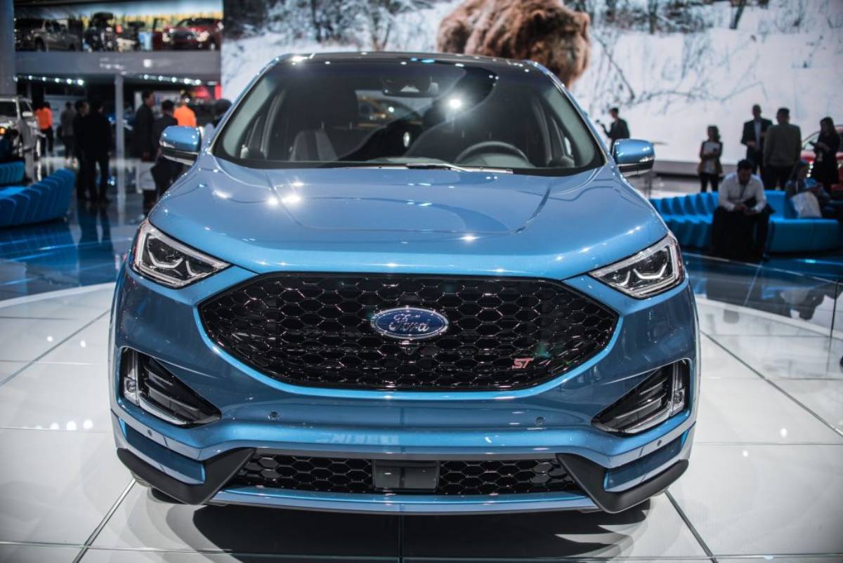 A blue 2018 Ford Focus on display at an auto show.